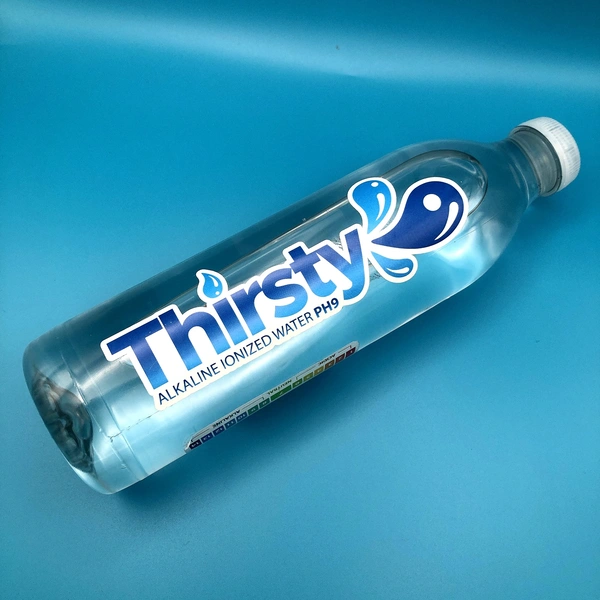 Bottle with a label saying 'Thirsty', with the label shaped around the letters